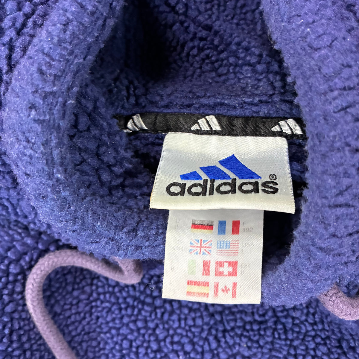 Adidas 1999 teddy hoodie size tag close-up