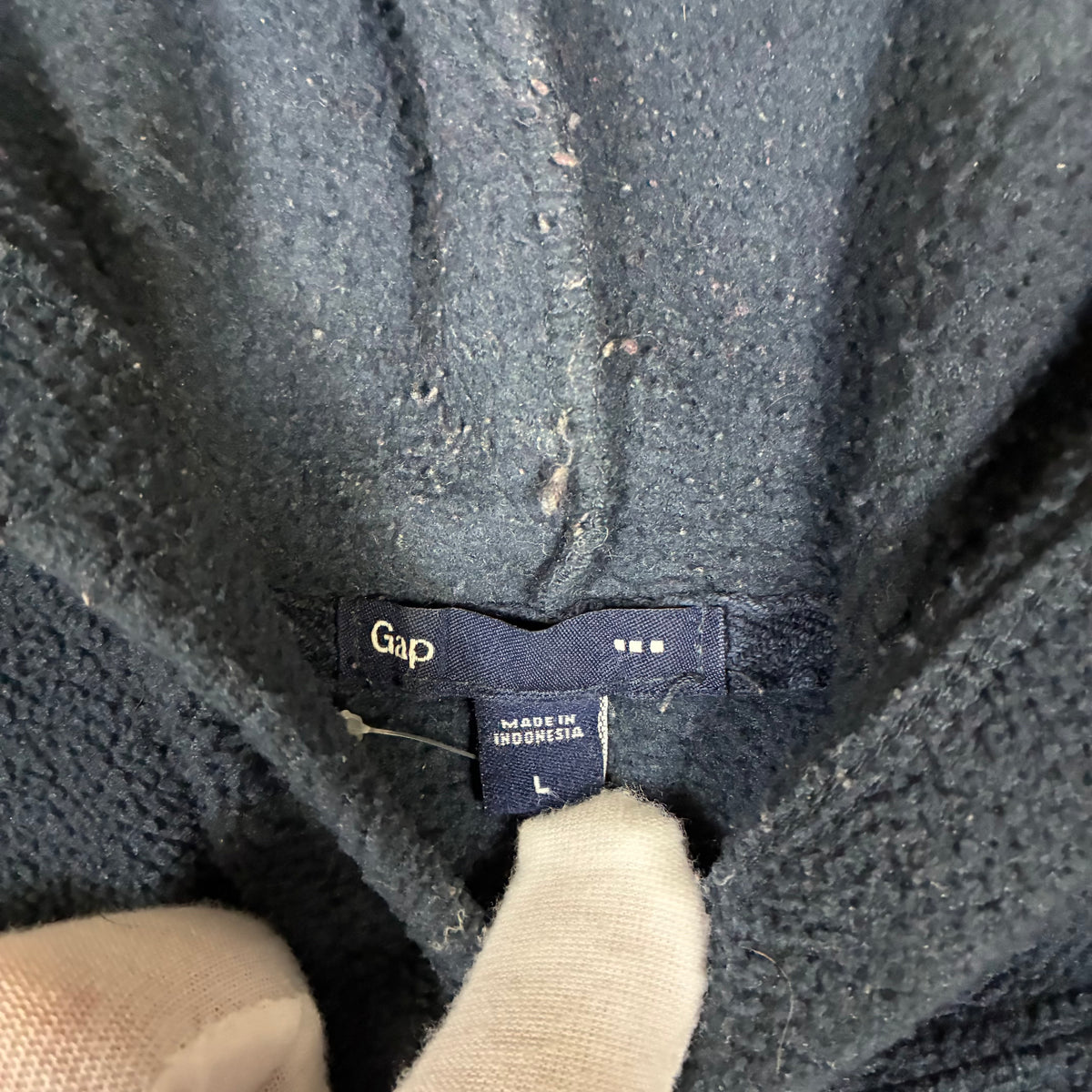 Gap spell-out logo close-up on black fleece hoodie