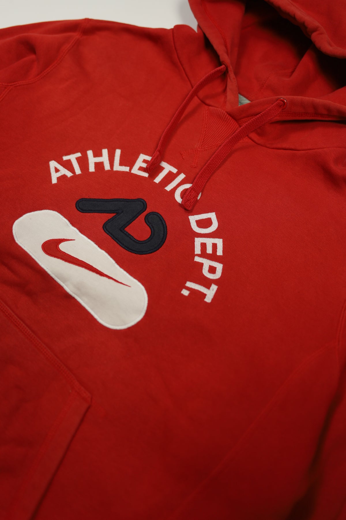 Nike red hoodie size tag close-up