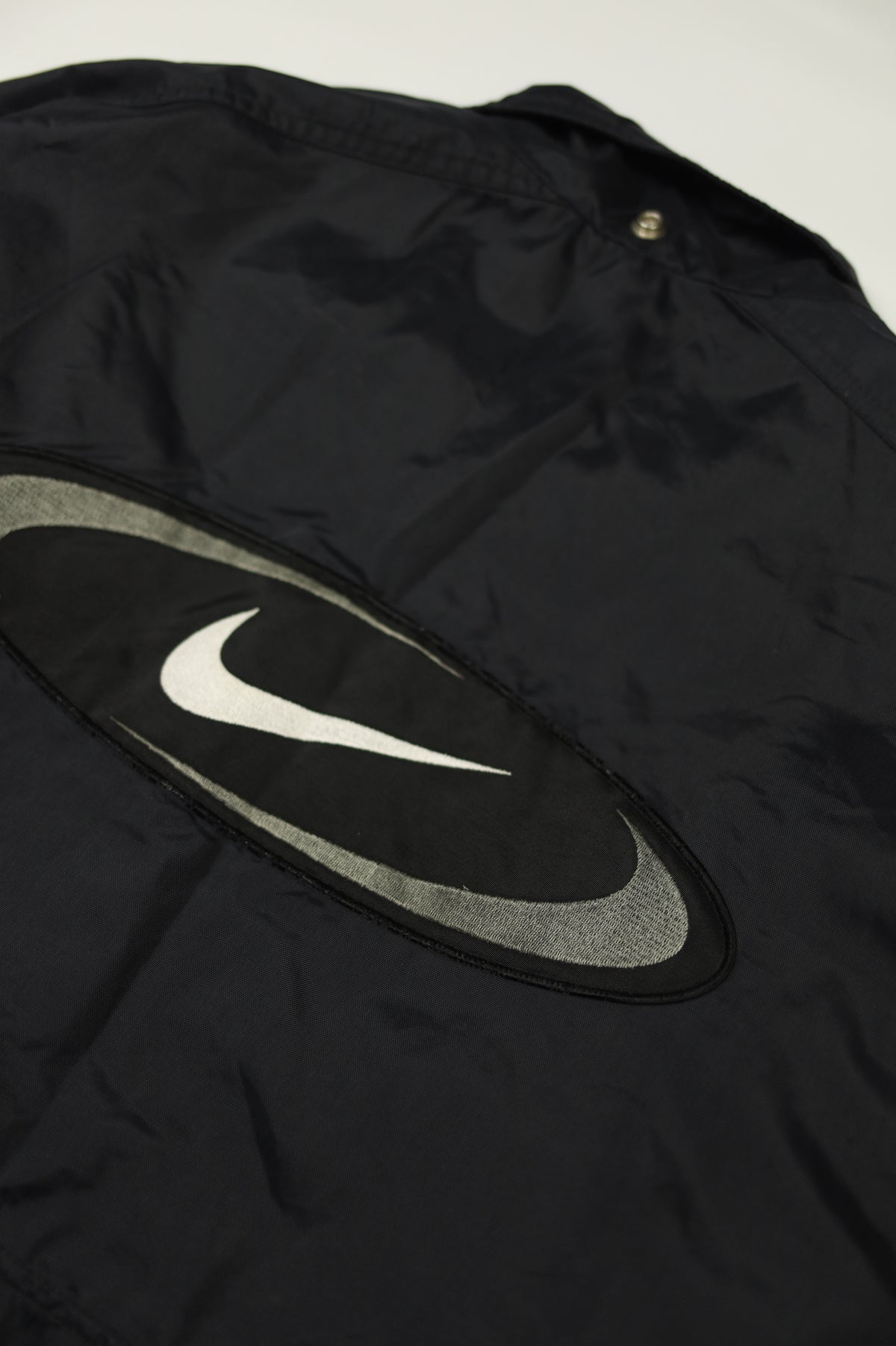 Nike big logo jacket size tag close-up