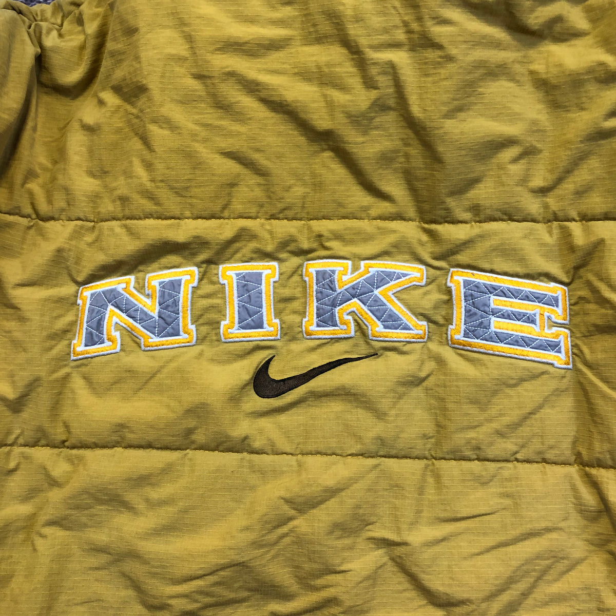 Vintage Nike swoosh on yellow puffer