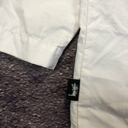 Stussy reflective jacket size tag