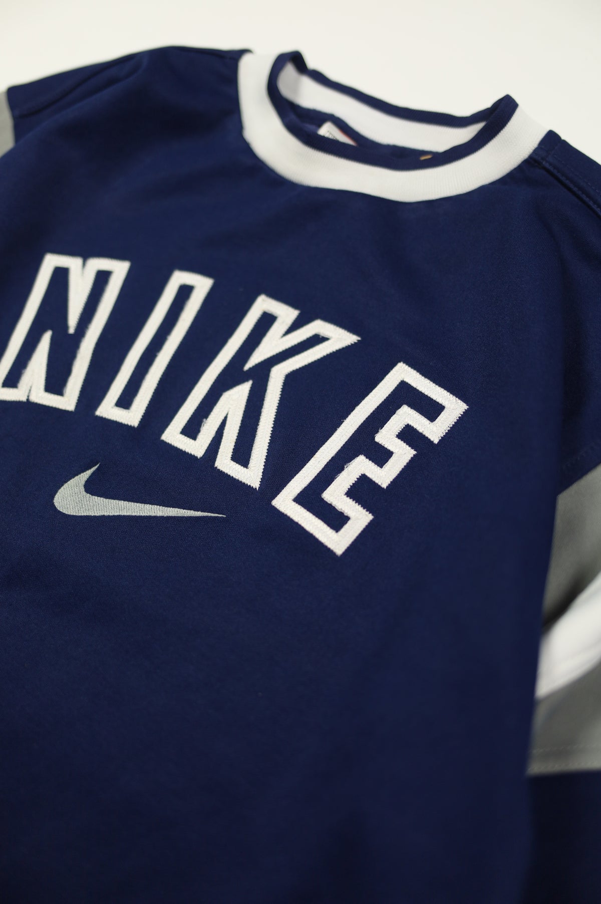 Vintage Nike big swoosh logo on blue sweatshirt